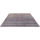 Intricately patterned vintage area rug with muted blue and red hues.