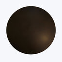 Mysterious dark circular object against a lighter background, open to interpretation.