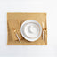 Elegant and rustic table setting with gold accents on white background.
