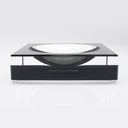 Contemporary elegance: A sleek acrylic bowl on a minimalist base.