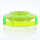 Contemporary green acrylic bowl set on a sleek tray surface.