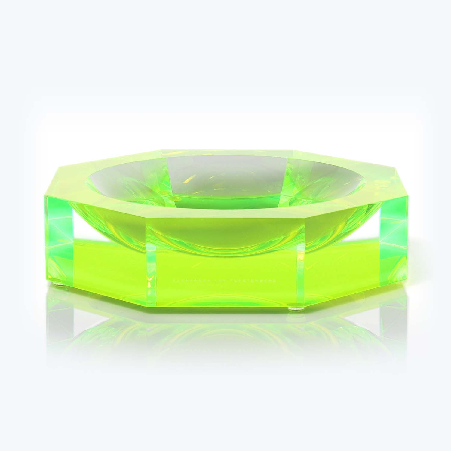 Vibrant green, geometric object with captivating light patterns, possibly glass.