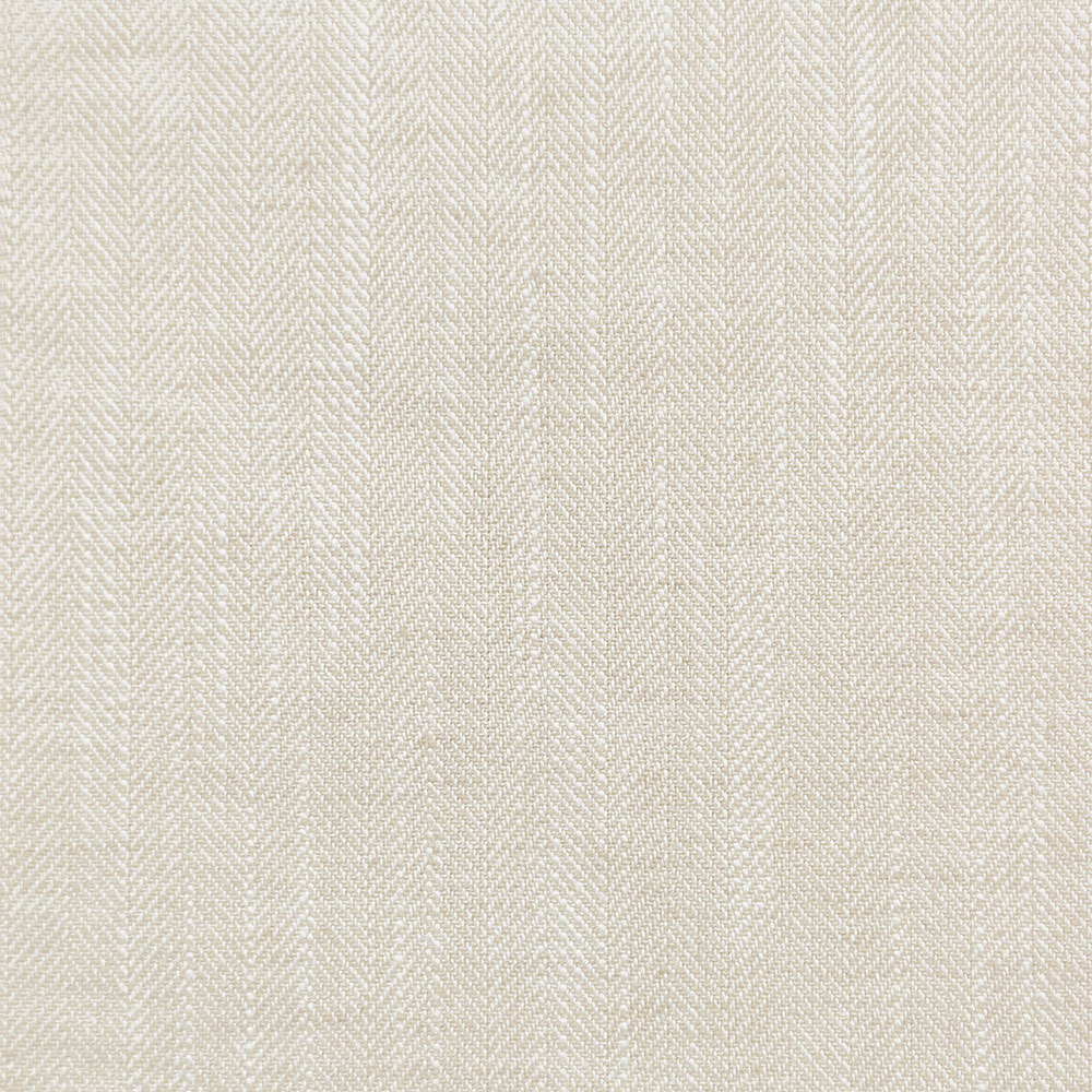 Close-up of textured twill weave fabric in light neutral tone.