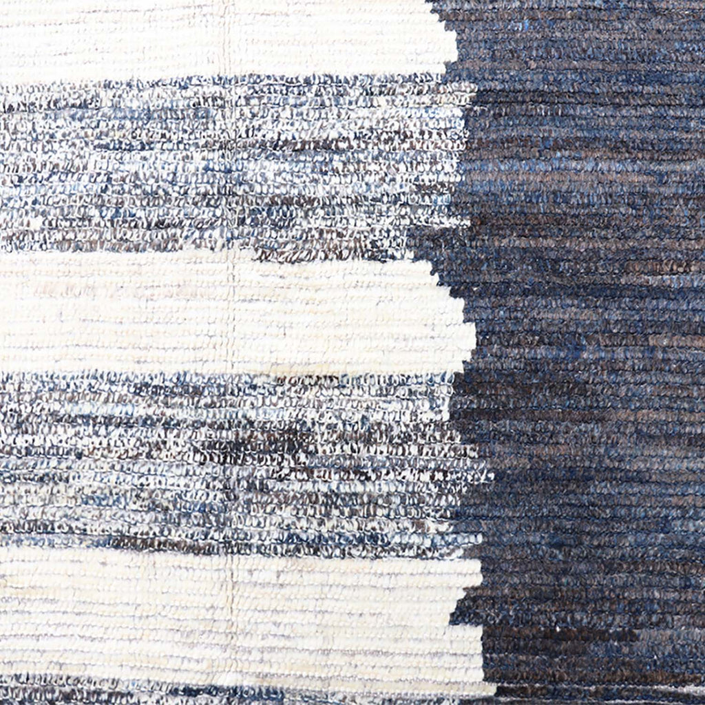 Close-up of handcrafted textured surface with striped pattern in blue and gray.
