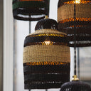 Multiple pendant lights made from woven materials create an inviting atmosphere.