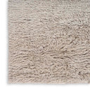 Close-up of a shaggy, light gray rug with fluffy texture.