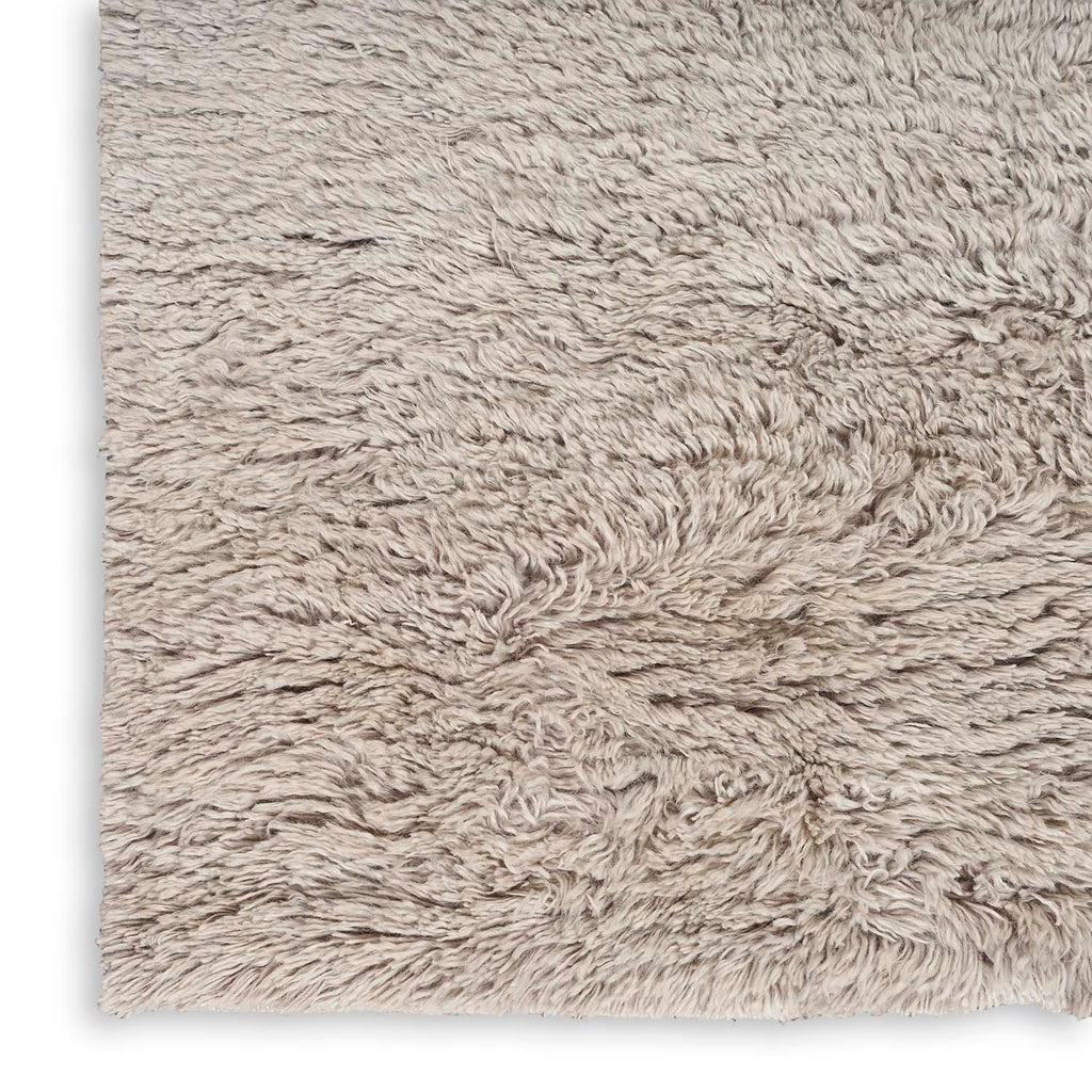 Close-up of a shaggy, plush fabric with soft, textured pile.