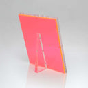 Translucent red acrylic panel with polished edges stands upright gracefully.
