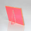Vibrant red acrylic table tent sign holder against grey background.