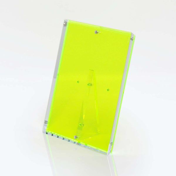 Neon green acrylic sign holder with contemporary design stands upright.