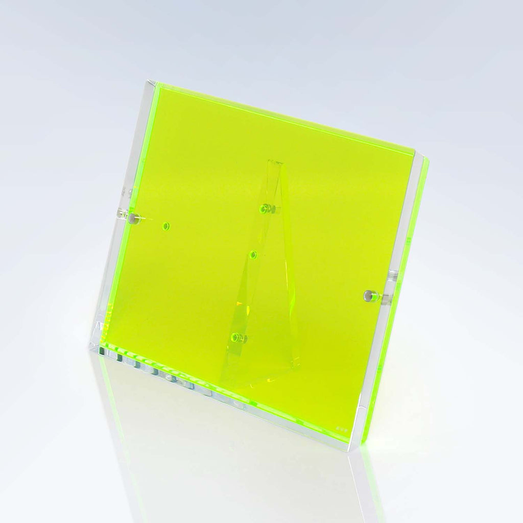 Neon green acrylic box emits a subtle green glow.