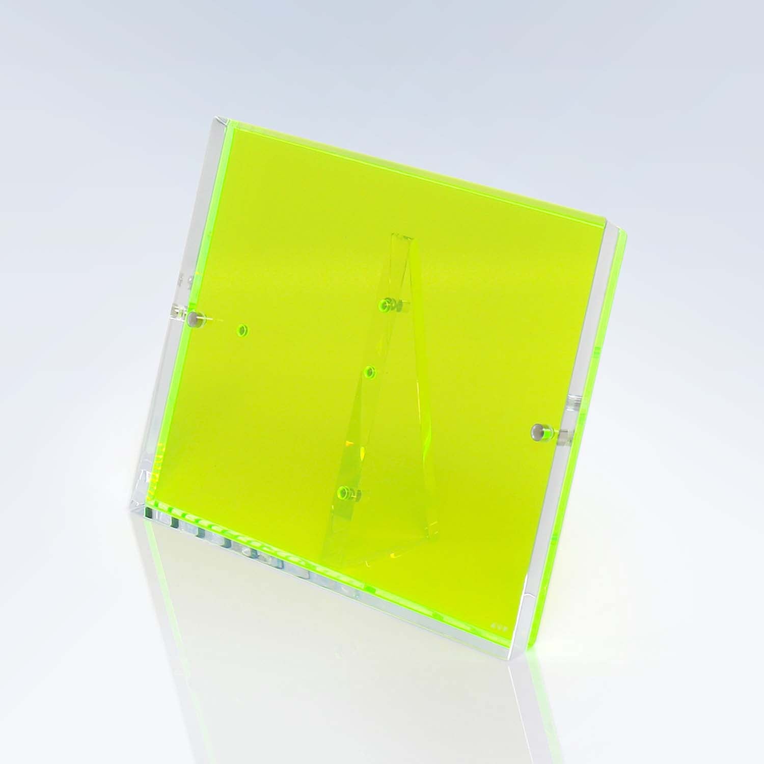 Neon green acrylic box emits a subtle green glow.