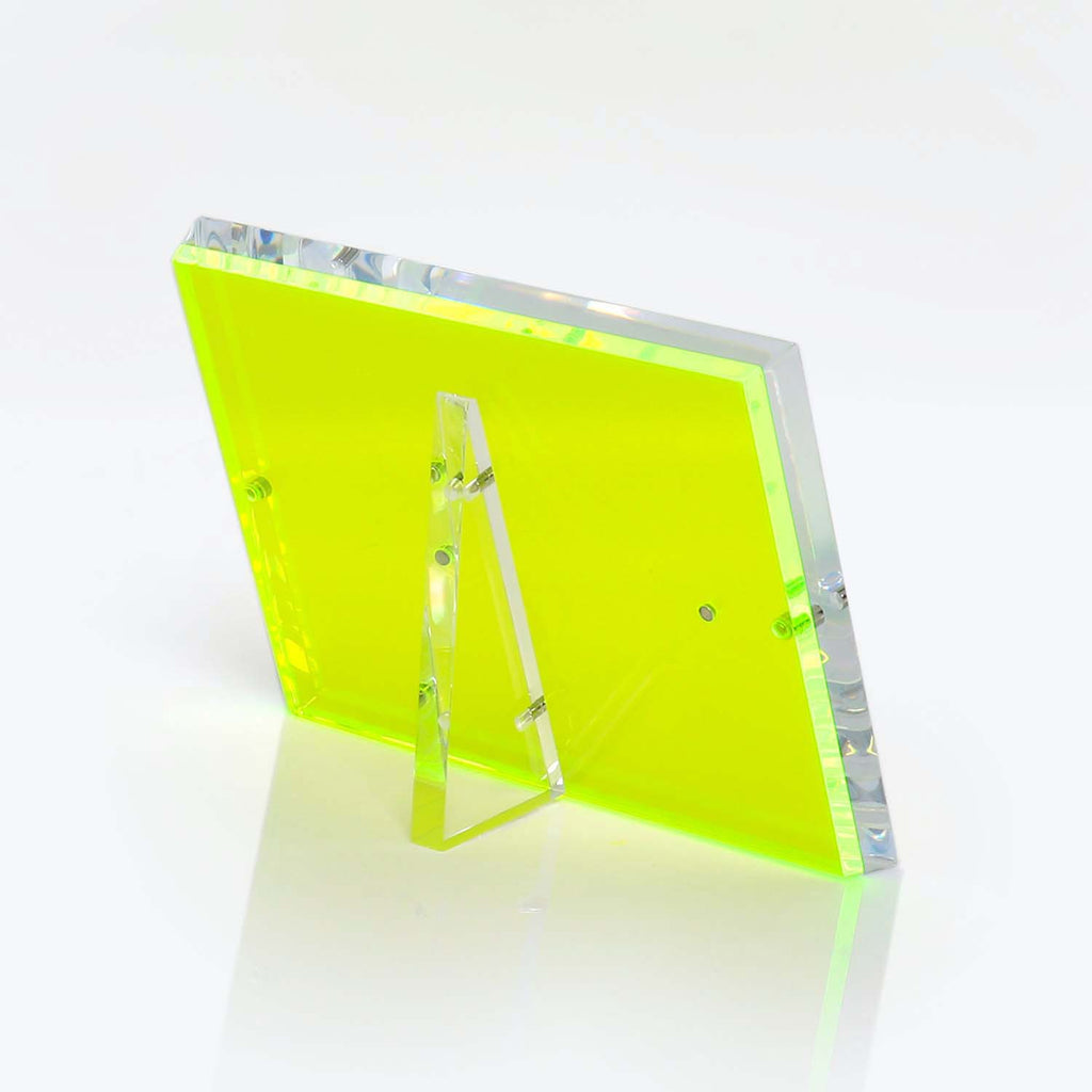 Transparent neon yellow acrylic display stand with prismatic effect.
