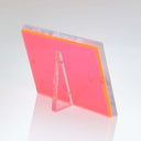 Fluorescent pink acrylic table tent with slanted design for menus.