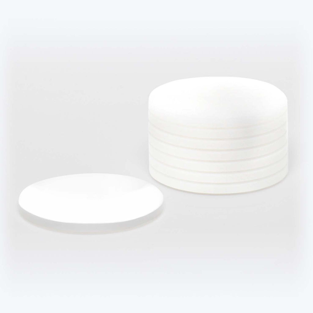 Minimalistic and modern design of identical ceramic plates in soft lighting.