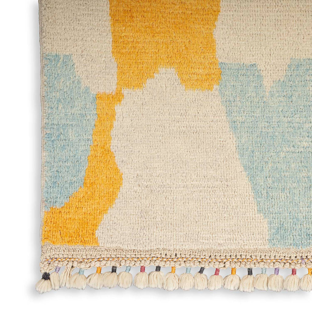 Abstract patterned woven textile with plush tufted construction and eclectic fringe.