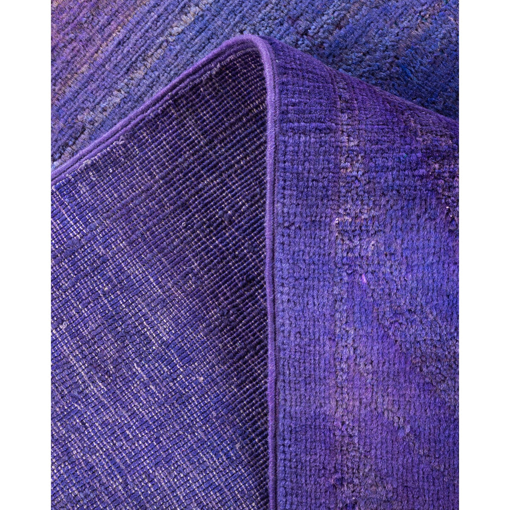 Close-up of purple fabric with contrasting textures and visible wear.