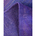 Close-up of purple fabric with contrasting textures and visible wear.