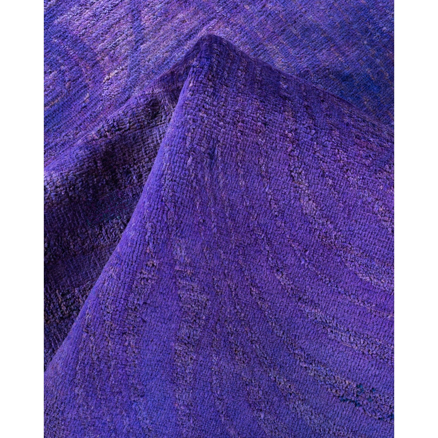 Close-up of textured purple fabric folds, showcasing depth and dimension.