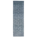 Vintage-inspired rectangular runner rug in shades of grey with distressed look.
