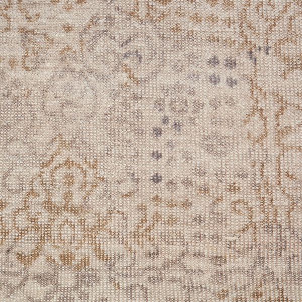 Close-up of textured fabric with floral motif in neutral tones.