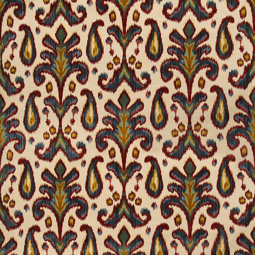 Close-up of intricate, symmetrical botanical fabric pattern with blue and green motifs.