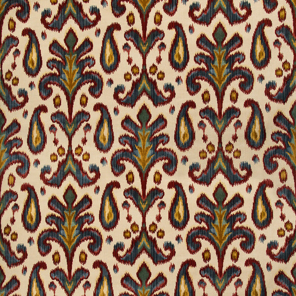 Close-up of intricate, symmetrical botanical fabric pattern with blue and green motifs.