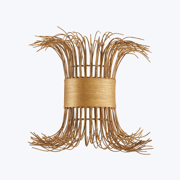 Symmetrical rattan object with flared ends and frayed appearance.