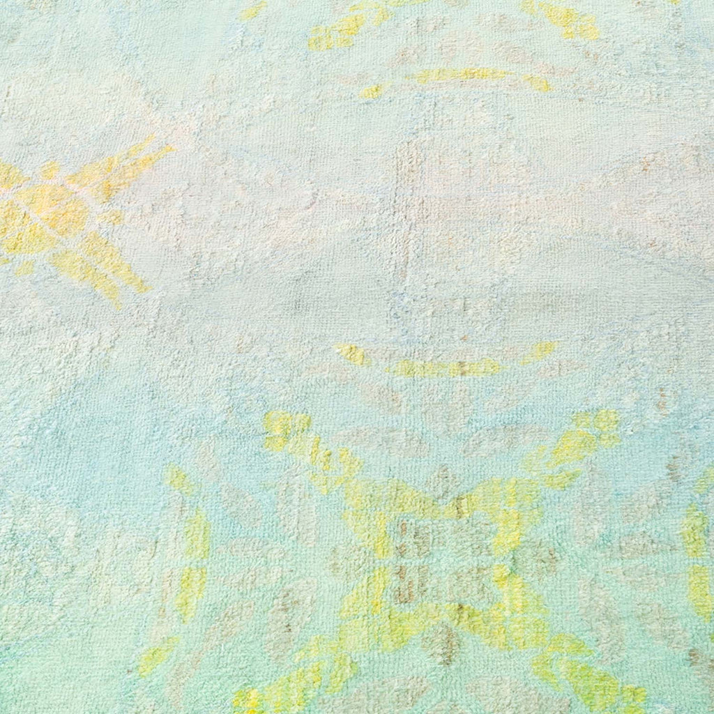 Close-up view of a pastel blue surface with faint yellow designs.