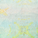 Close-up view of a pastel blue surface with faint yellow designs.