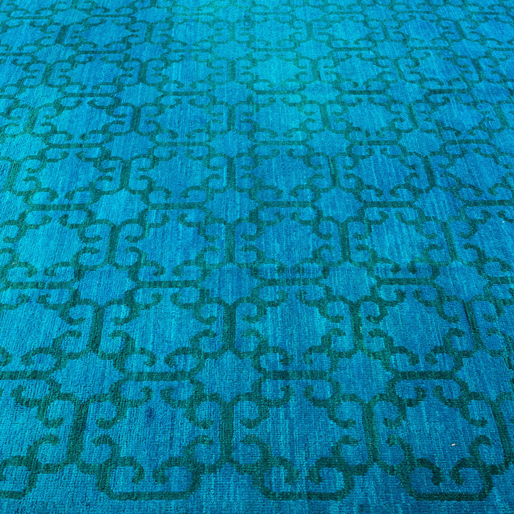 Close-up of a vibrant blue carpet with an intricate design.