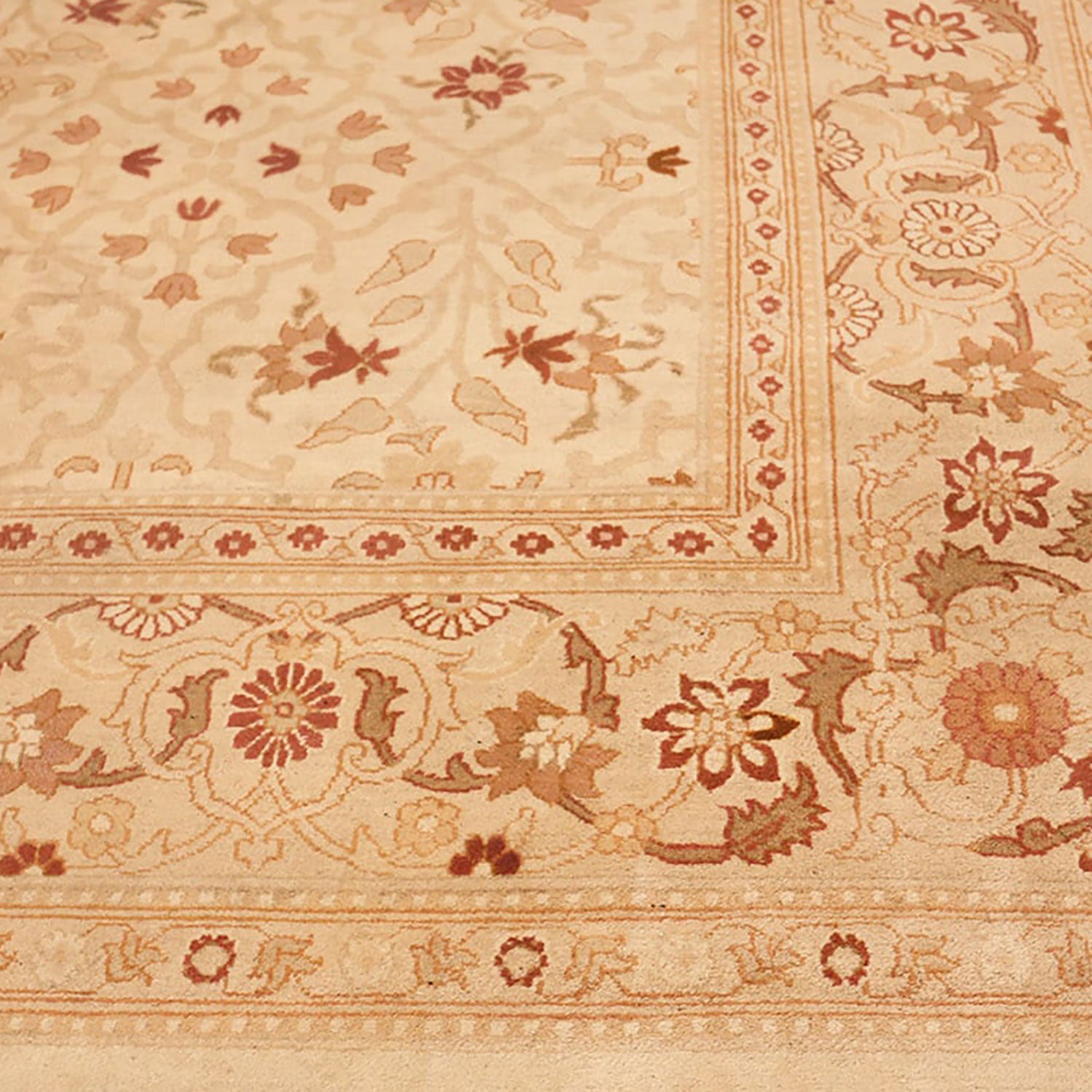 Intricately designed rug with floral and botanical patterns in earthy tones.