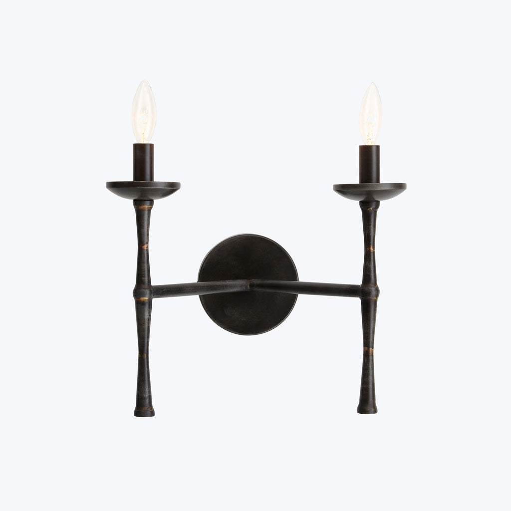 Wall-mounted electric candle sconce with flame-shaped light bulbs for ambiance.