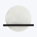 Minimalist art piece featuring a textured white circle with intersecting black line.