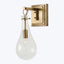 Wall-mounted light fixture with brass finish and vintage-inspired design.