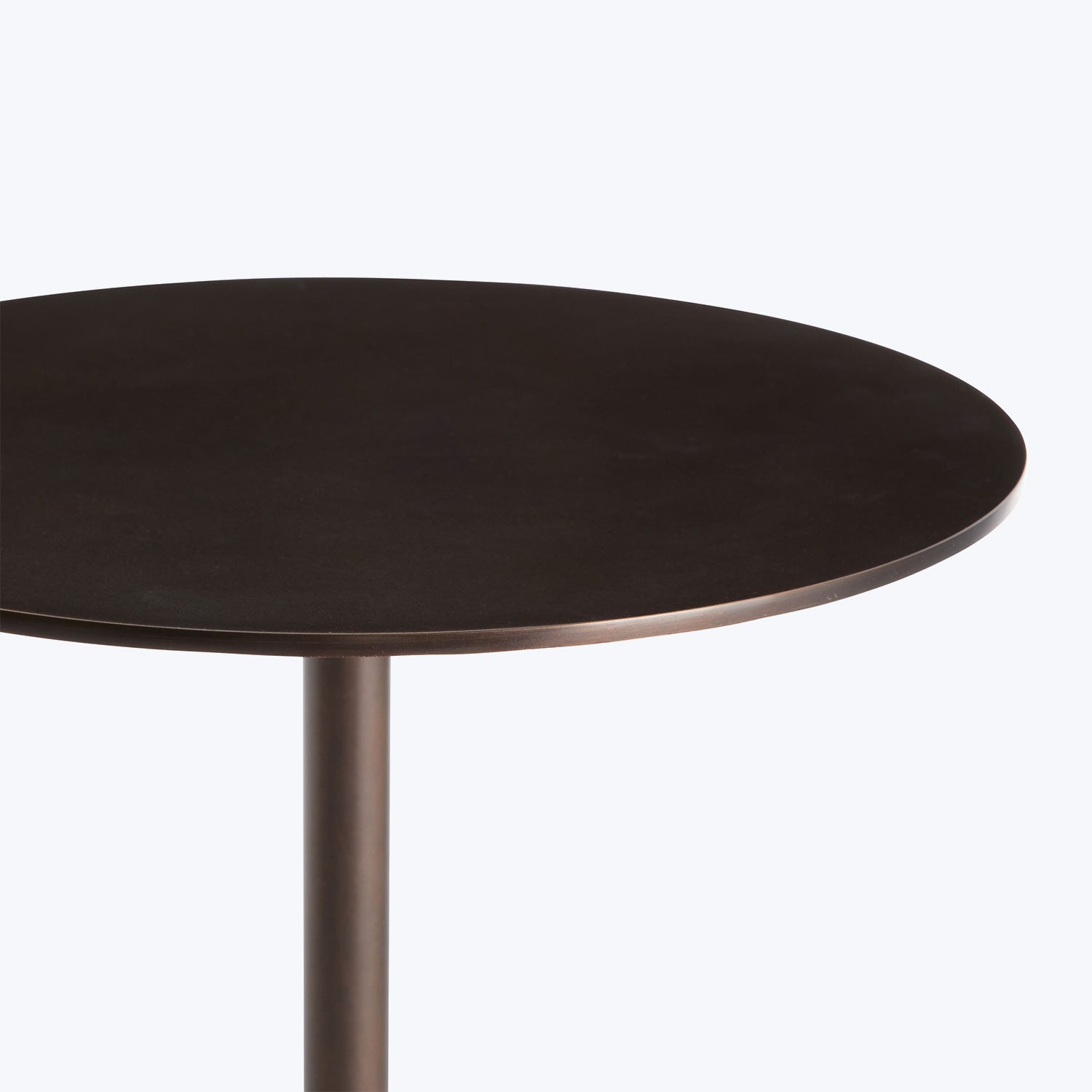 Close-up of a stylish dark circular tabletop with beveled edge.
