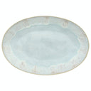 Oval ceramic plate with speckled design in light blue/aqua color.