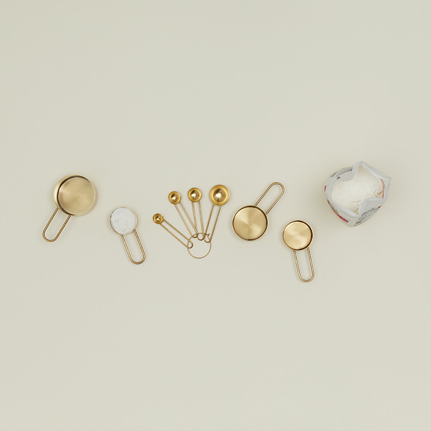 An elegant assortment of metallic objects against a minimalistic background.
