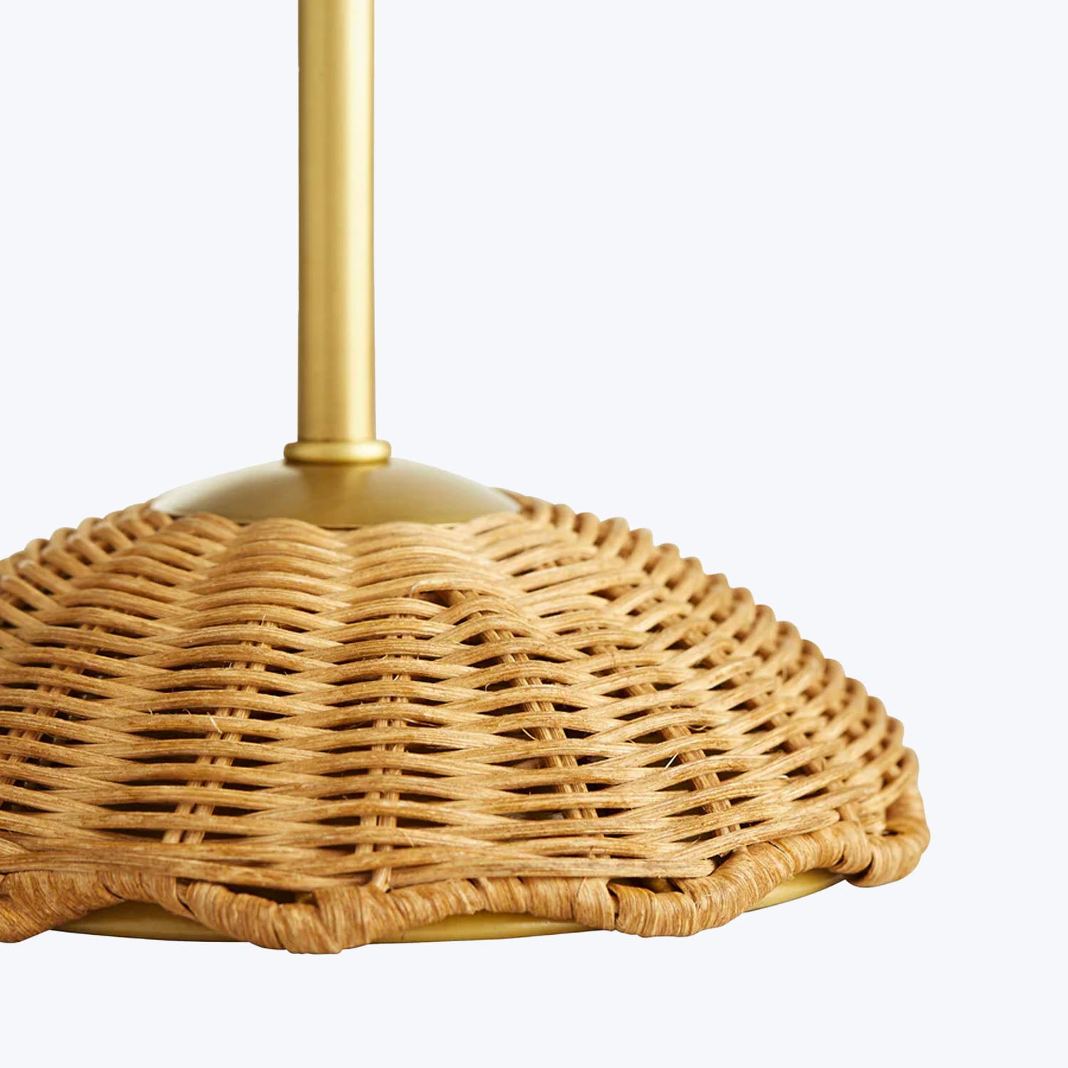 Close-up view of a wicker pendant lamp with intricate dome-like pattern.