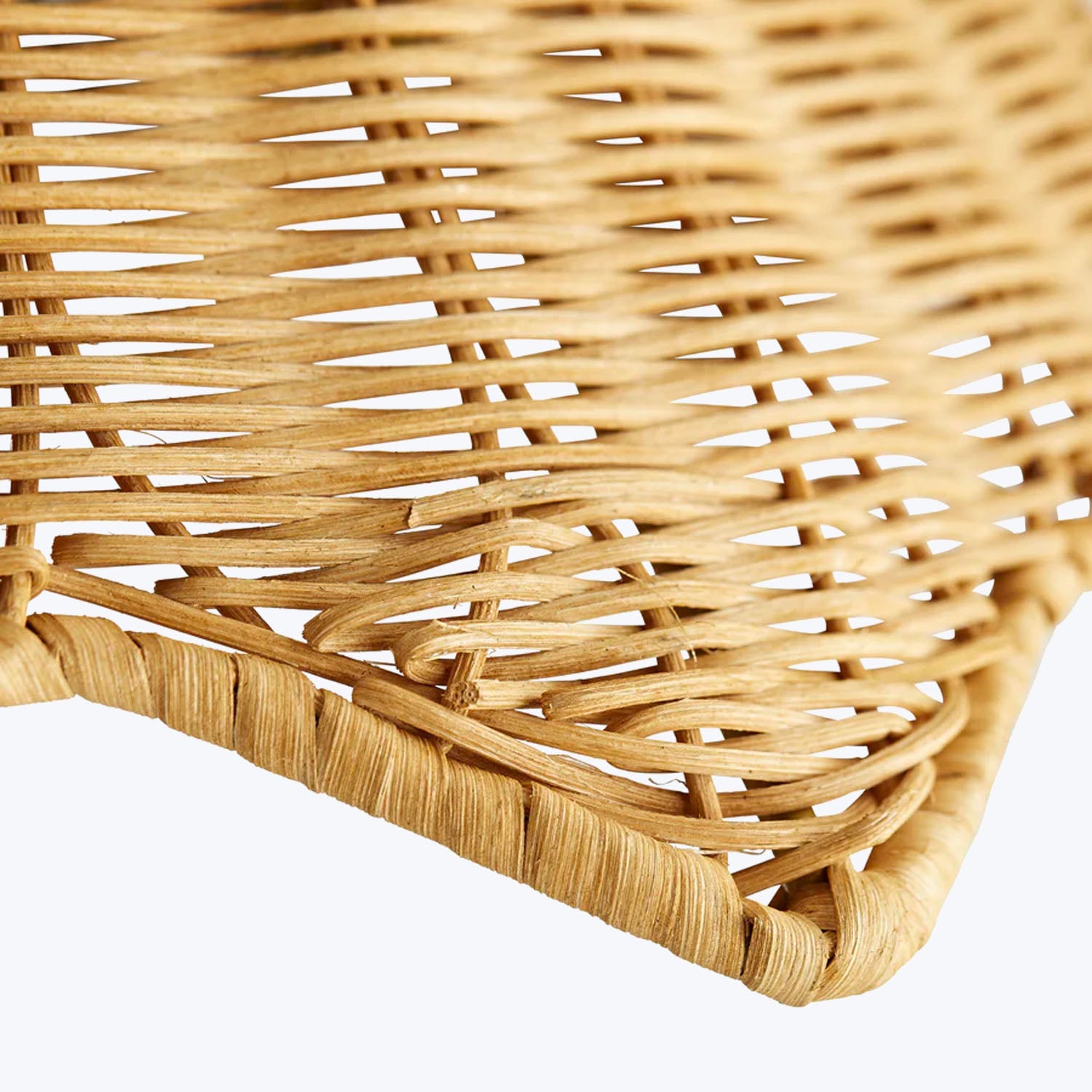 Close-up of a beautifully woven wicker object, showcasing intricate craftsmanship.