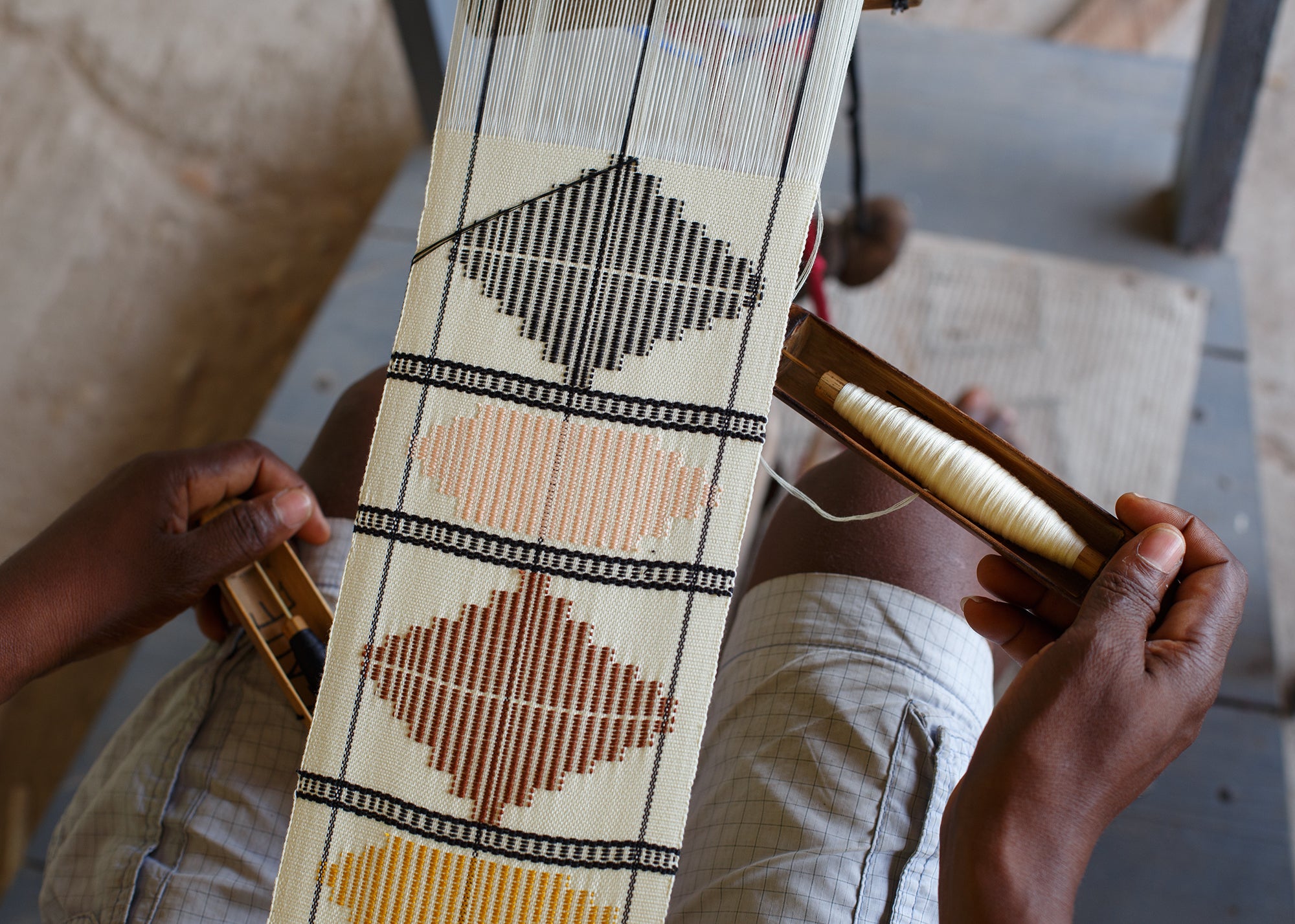 fabric being woven with traditional geometric design