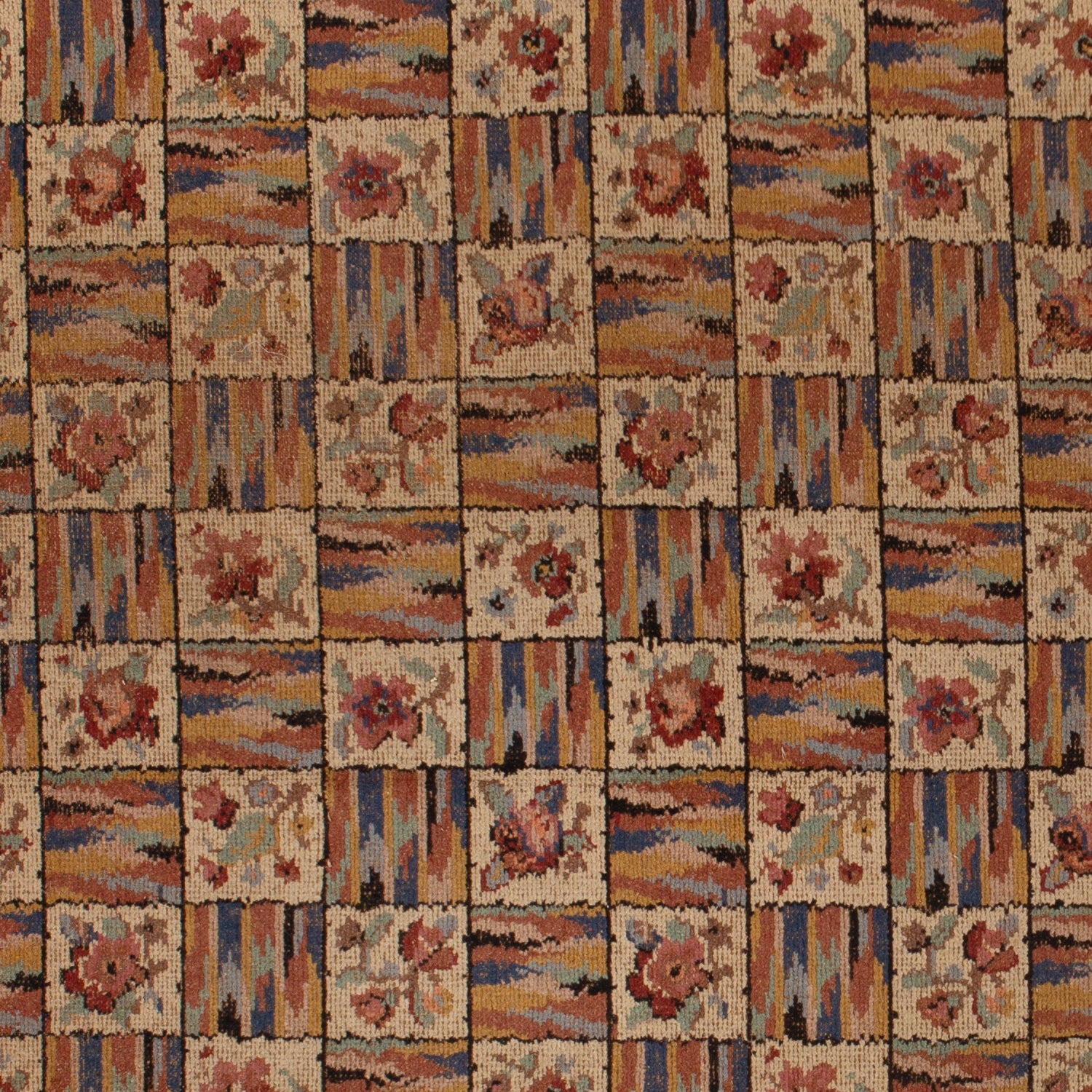 Close-up view of rustic floral patterned textile in earth tones.