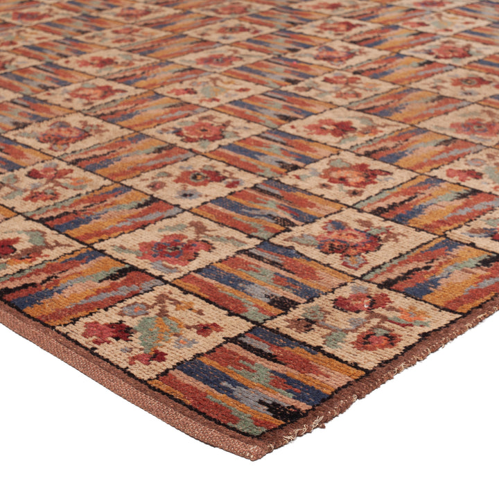 Geometric floral patterned rug in warm tones with intricate design.