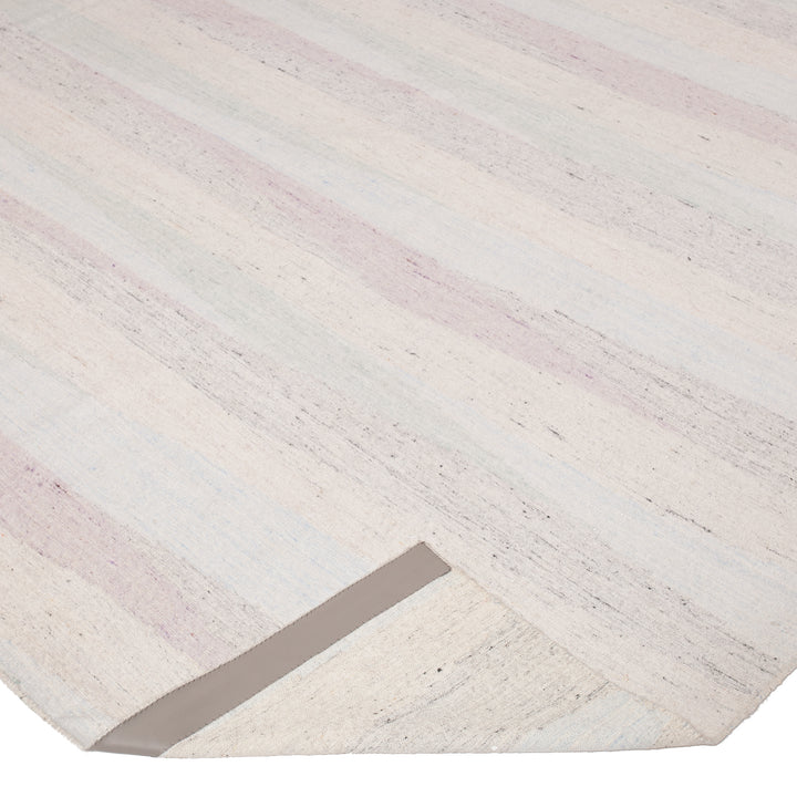 Close-up of contemporary striped rug in soft, muted colors