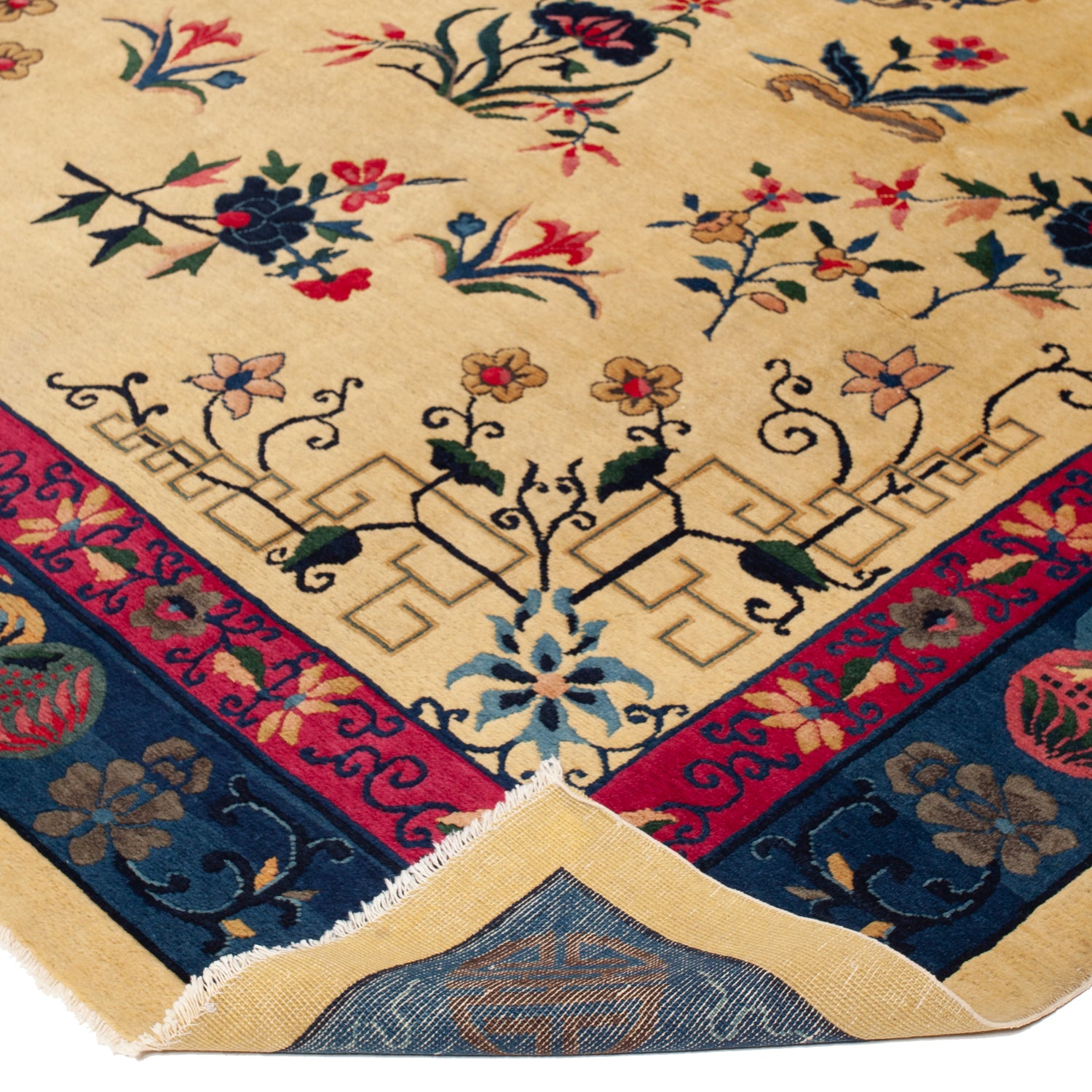 Close-up of ornate floral patterned rug with vibrant colors.