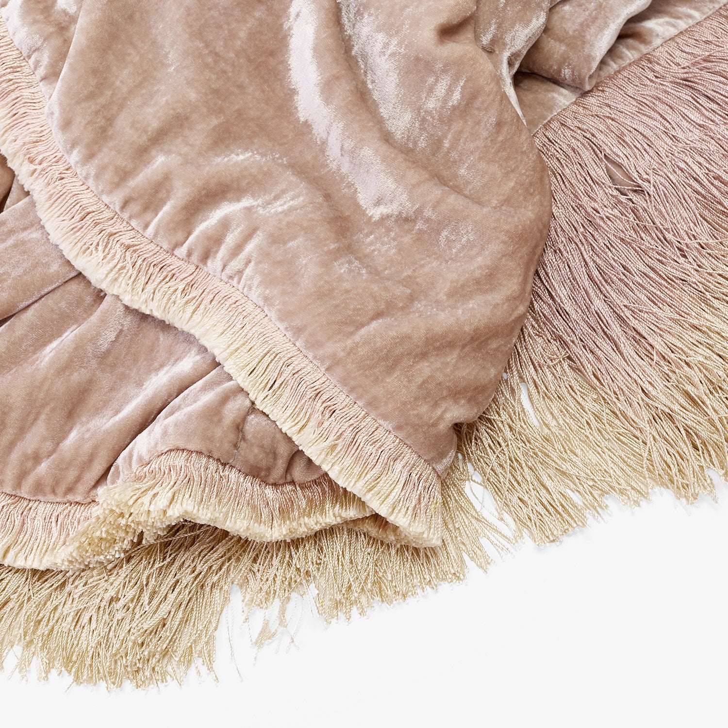 Soft pastel fabric with ombre fringe detail; cozy home decor.