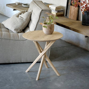 Minimalist wooden table with three legs and round tabletop. - hover