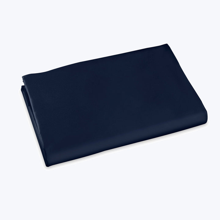 Neatly folded dark blue fabric on light background, smooth texture.