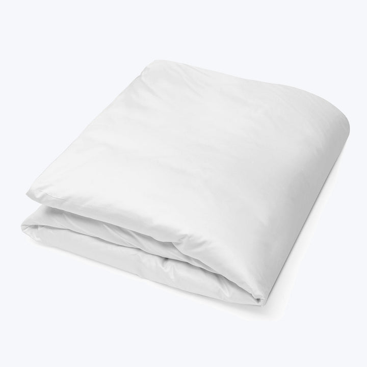 Neatly folded white duvet cover on flat surface, soft fabric.