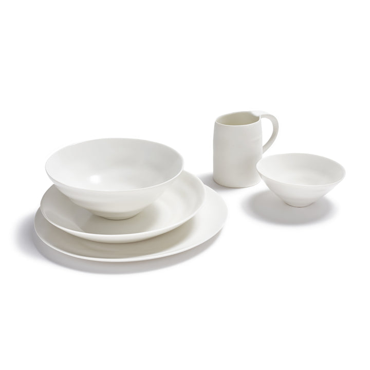 Set of white dinnerware including plates, bowls, and mug.